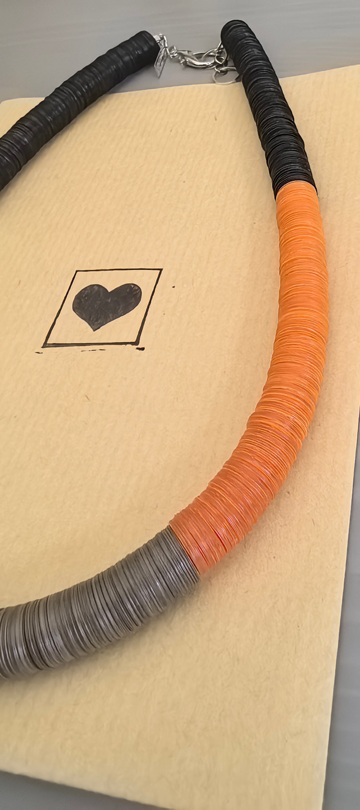 Round black, green, orange, and Fendi necklace