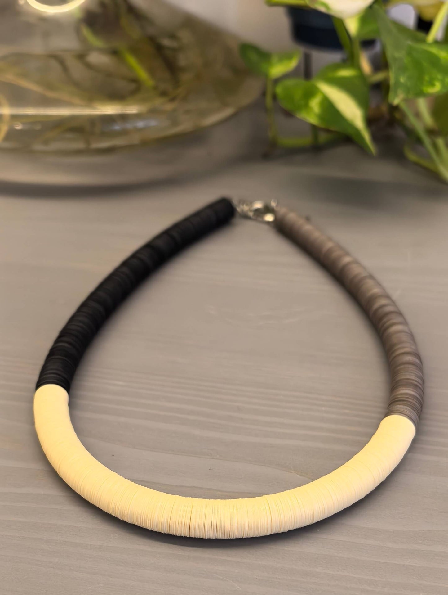 Black, cream, and Fendi round necklace
