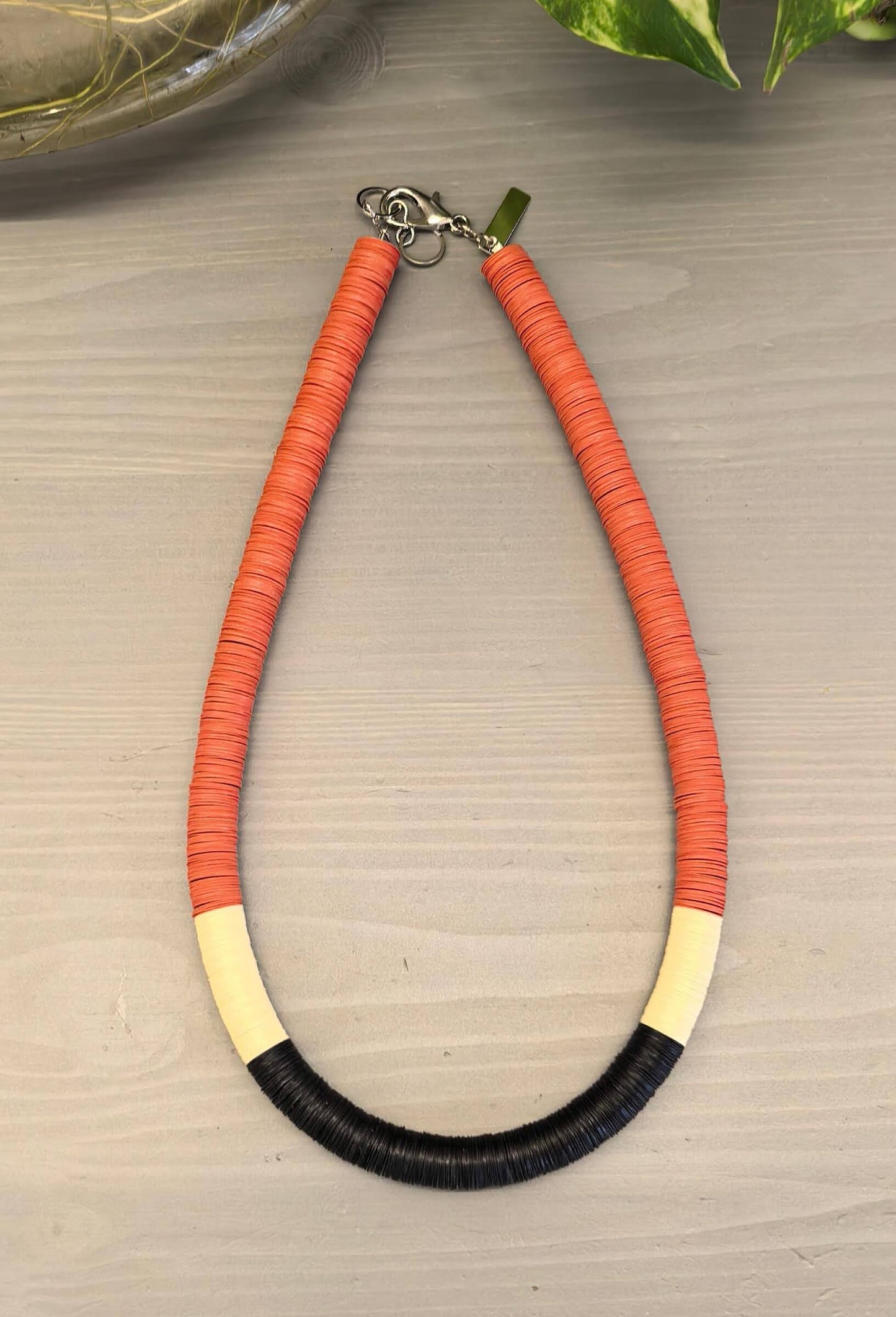 Round orange, cream, and black necklace