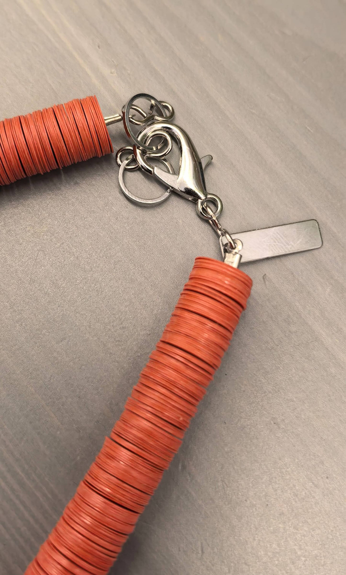 Round orange, cream, and black necklace