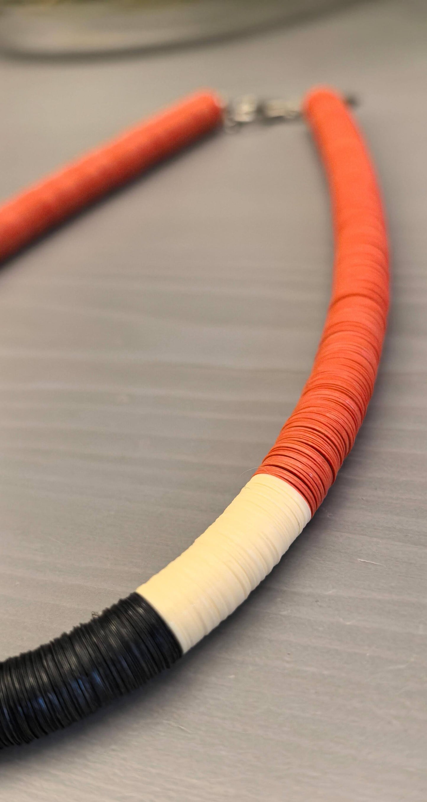 Round orange, cream, and black necklace