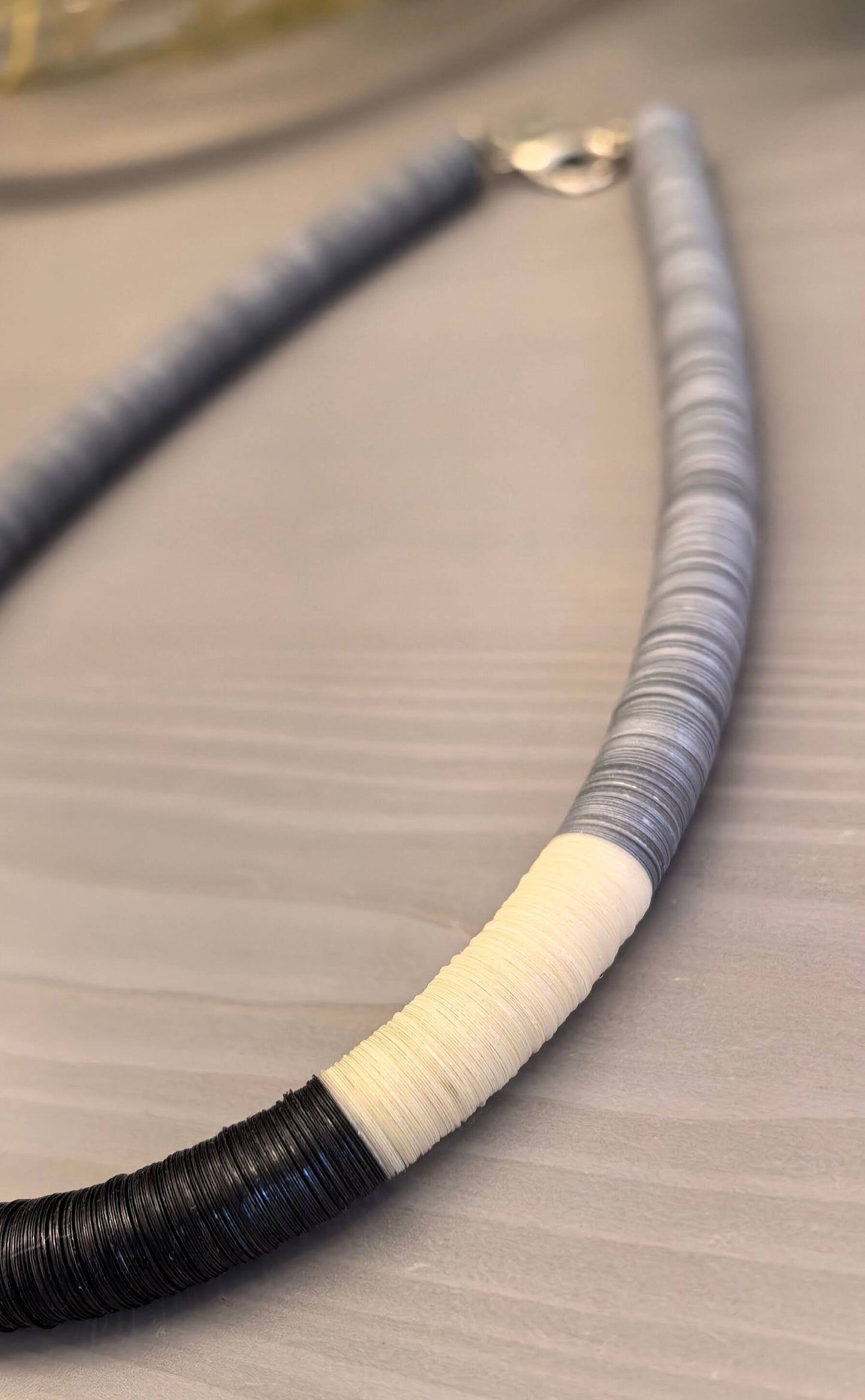 Round necklace in grey, off-white, and black