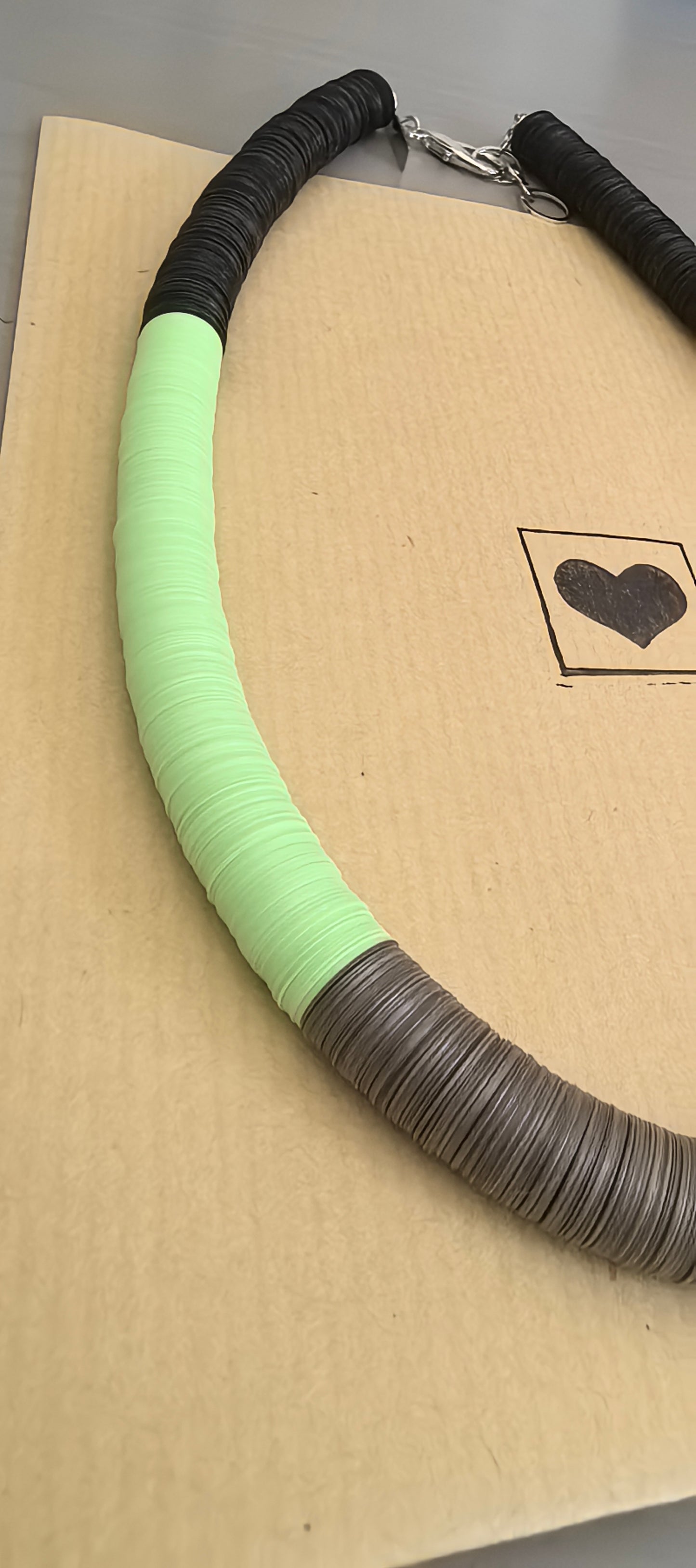 Round black, green, orange, and Fendi necklace