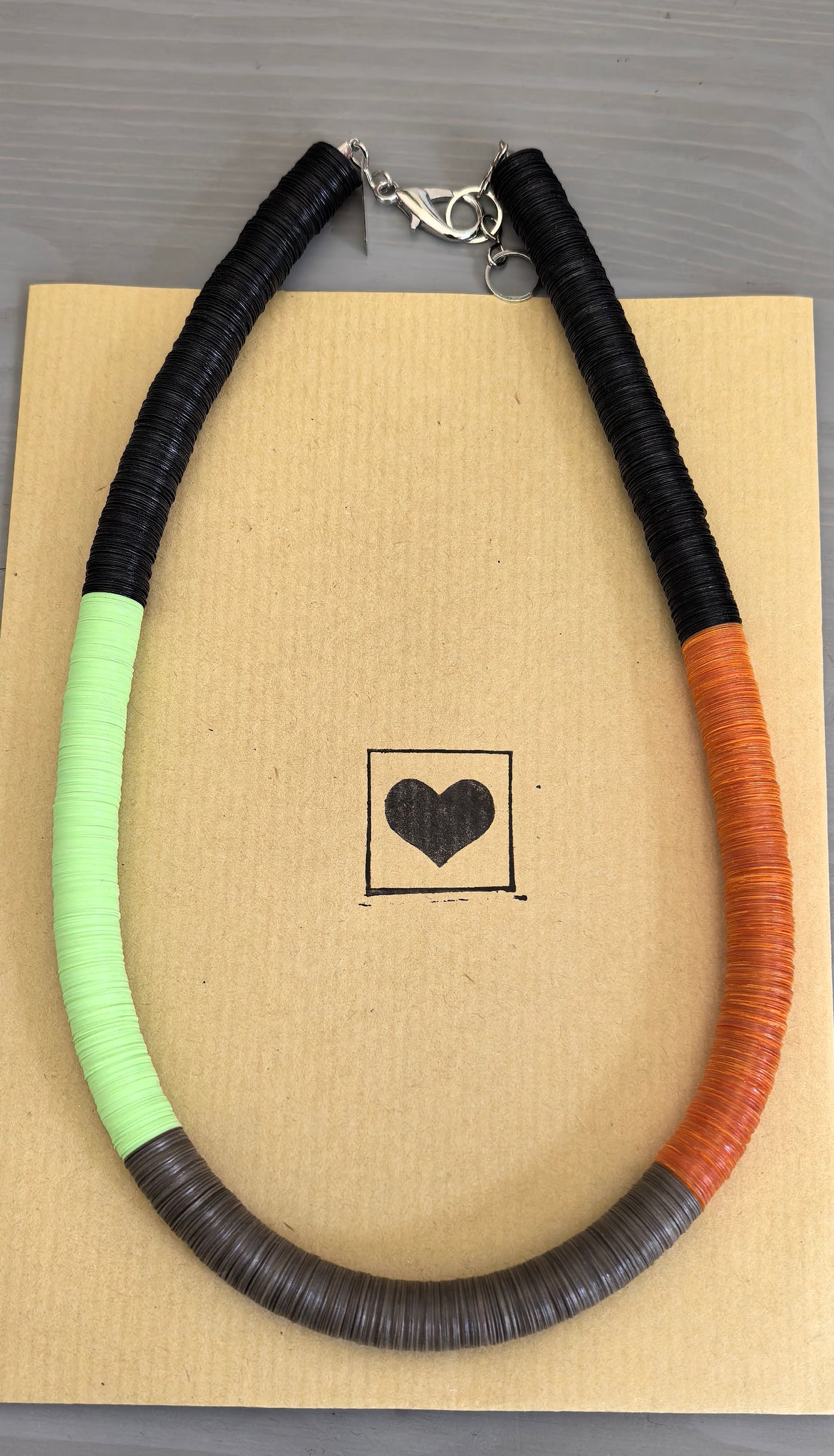 Round black, green, orange, and Fendi necklace