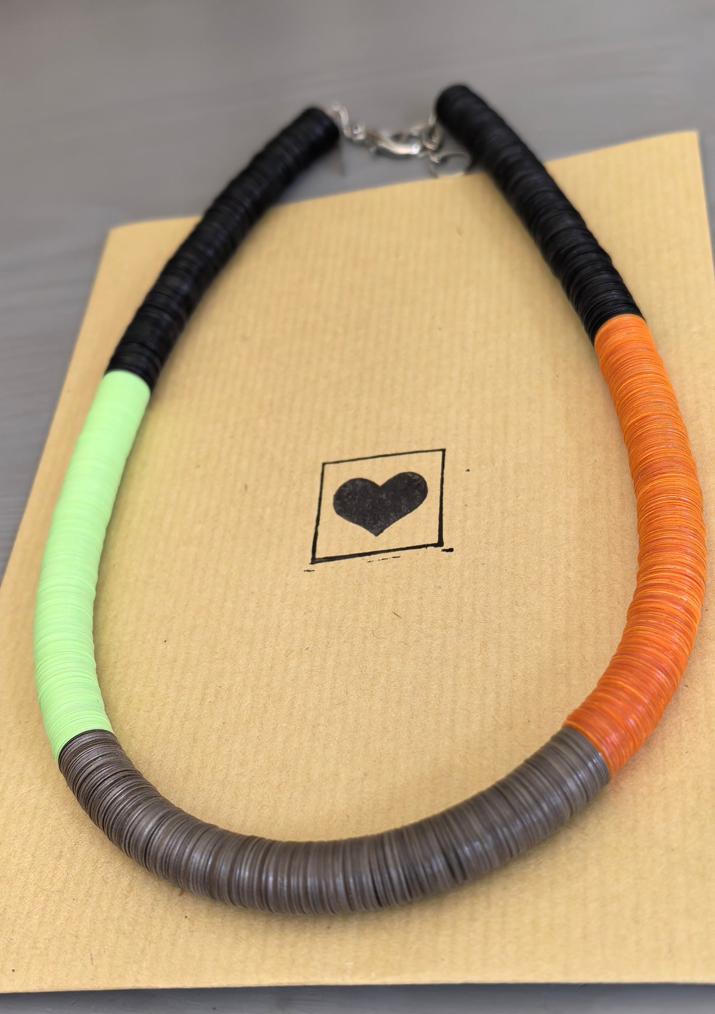 Round black, green, orange, and Fendi necklace