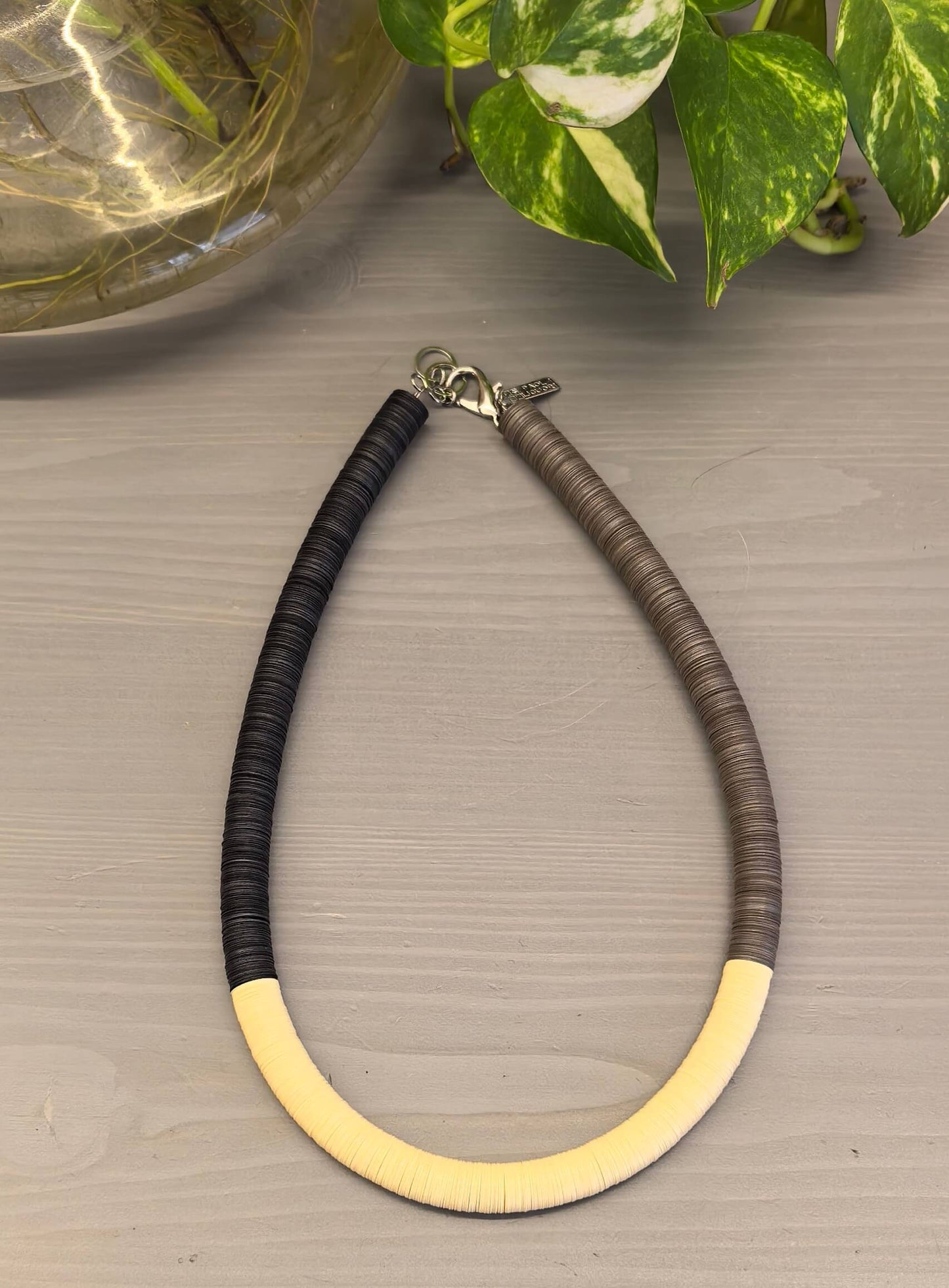 Black, cream, and Fendi round necklace
