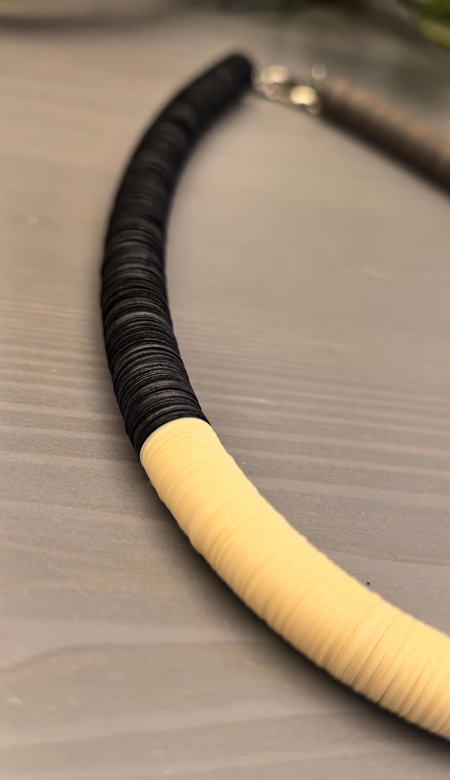 Black, cream, and Fendi round necklace