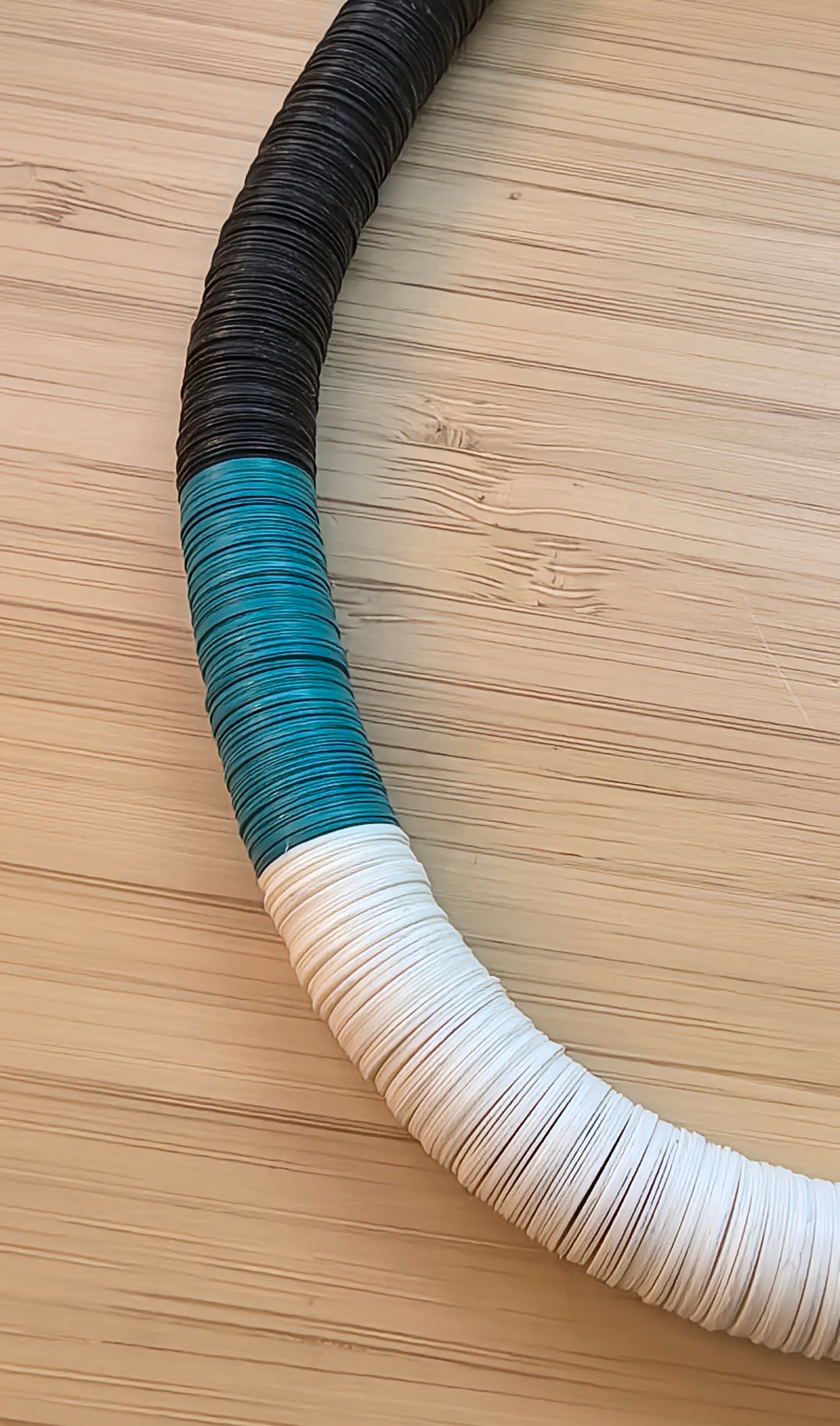 Round necklace in black, turquoise, and off-white